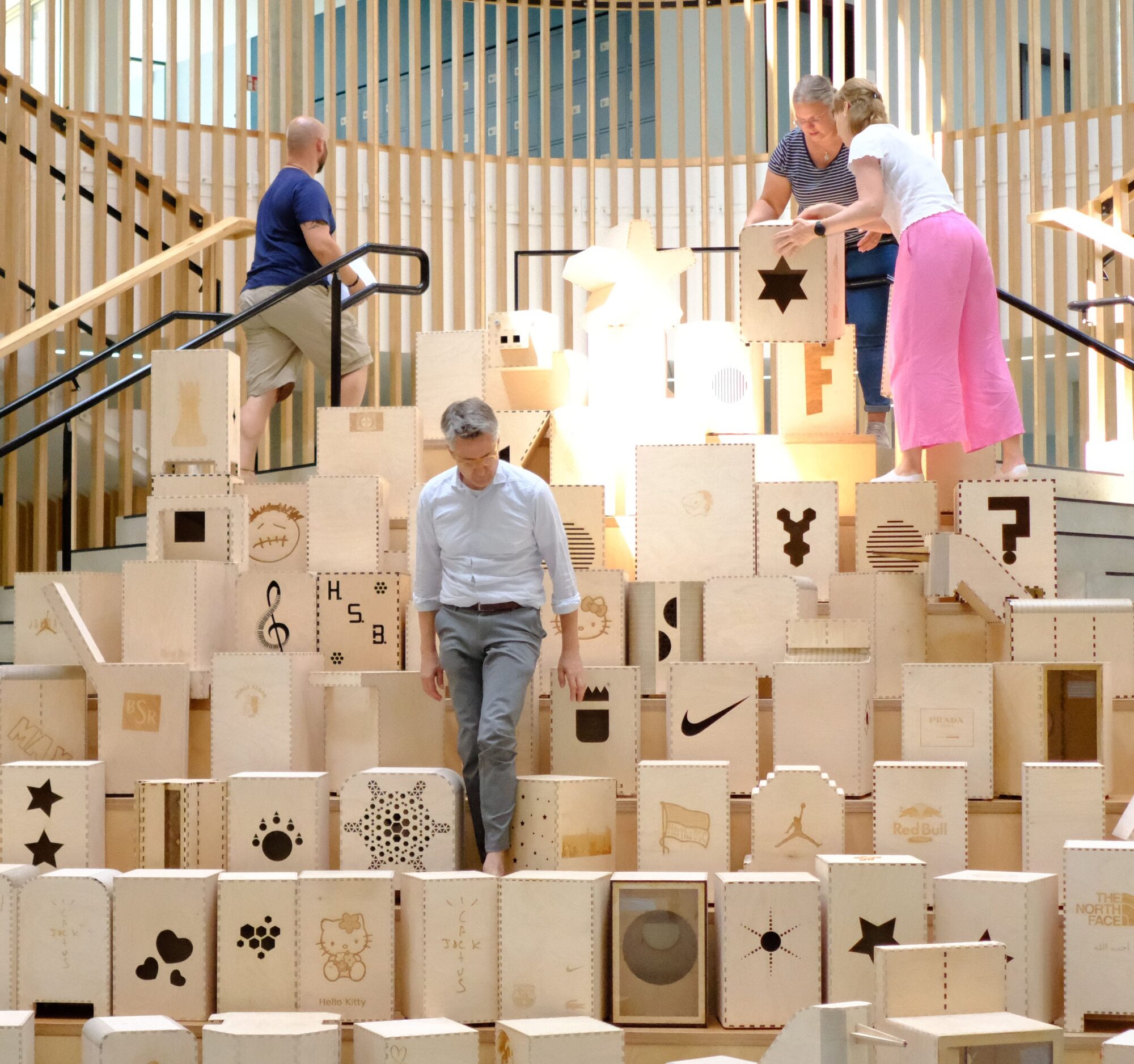 people on stairs arranging lasercut cajons